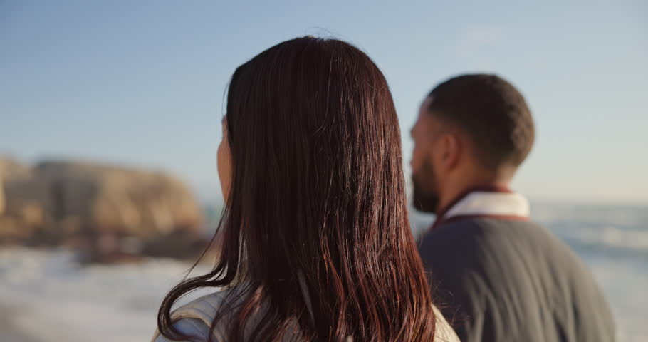 Walking, beach and face of couple holding hands by ocean for commitment, bonding and relax in nature. Happy, travel and portrait of man and woman for romance on holiday, vacation and anniversary