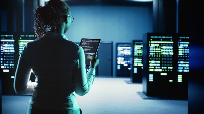Engineer walking in server room housing advanced infrastructure storing massive datasets. Worker running code on tablet to upgrade data center rigs doing complex computational operations Royalty-Free Stock Footage #1108668657