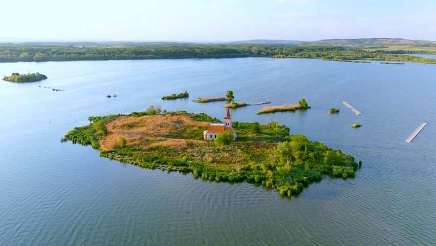 Aerial view of Kostel sv. Linharta church, the only remainder of once important town of Musov, located on small island in the middle of manmade Vestonice reservoir. South Moravia, Czech Republic Royalty-Free Stock Footage #1108669427