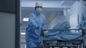 Professional surgeons take patient from surgery to hospital room down medical center hallway. Young female medic opens doors from surgery block for colleagues. Patient lies on gurney after operation. - Powered by Shutterstock - Get 15% off with code: PIKWIZARD15