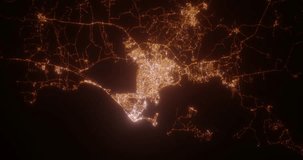 Cartagena (Colombia) aerial view at night. Top view on modern city with street lights. Camera is zooming out, rotating counterclockwise. Vertical video. The north is on the left side