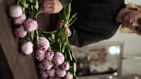 Florist making bouquet in flower shop Vertical ES - Powered by Shutterstock - Get 15% off with code: PIKWIZARD15