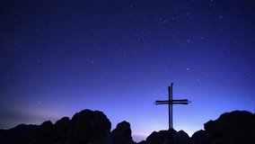 Milky Way and stars moving in the night sky above the cross, time-lapse video 