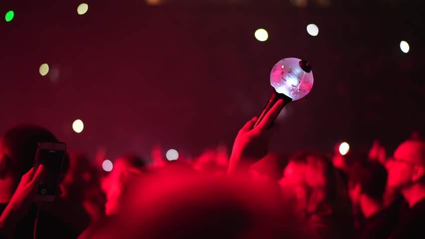 Bts k pop band fan raise hand up hold bomb light stick lamp. Fun korean people enjoy kpop live music concert. Crowd hang out cool night show. Asian idols army wave red flash light. Joy party fest asia