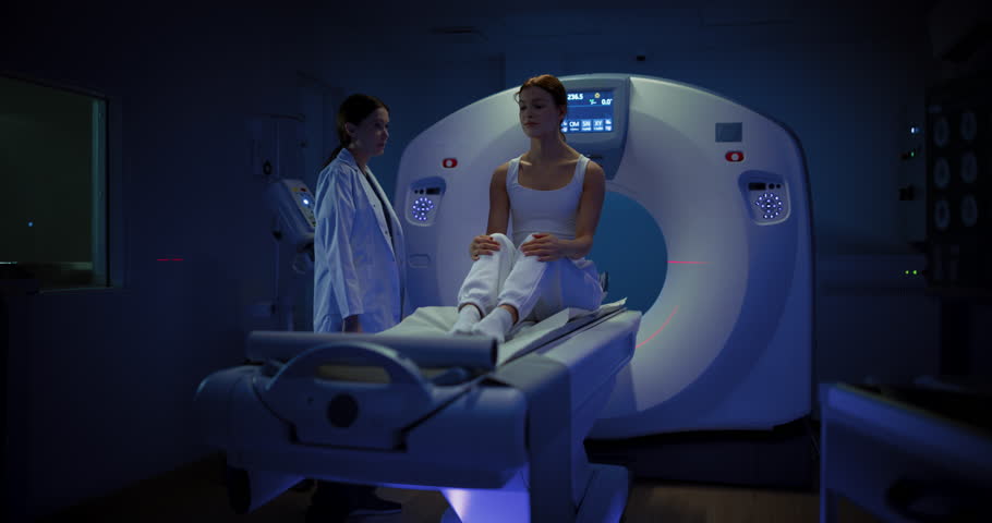 In Medical Laboratory, Radiologist Controls MRI or CT or PET Scan with Patient Undergoing Procedure. Professional Female Doctor Conducts Emergency Check Up Procedure with Advanced Medical Technologies Royalty-Free Stock Footage #1108680961