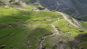 Motorcycle trip on Transfagarasan road in Carpathian Mountains Romania Cinematic drone aerial 4K video
