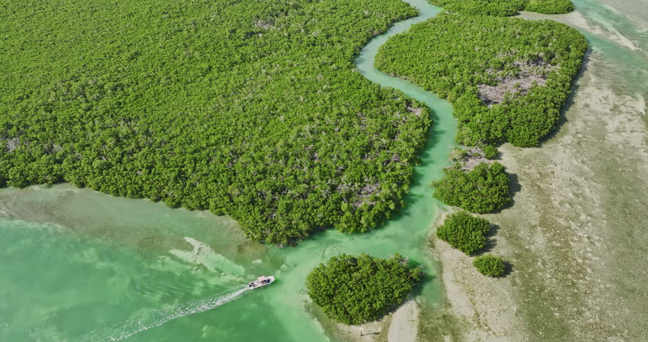 Key West Florida Aerial v27 cinematic birds eye view drone flyover and around Mud Keys capturing a boat sailing through the channel into the mangrove forests 