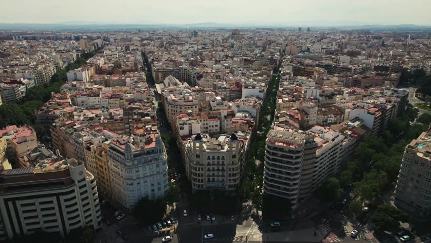Aerial view of typical Valencia houses with skyline of the city and roads full of trees, Valencia, Spain Royalty-Free Stock Footage #1108687215