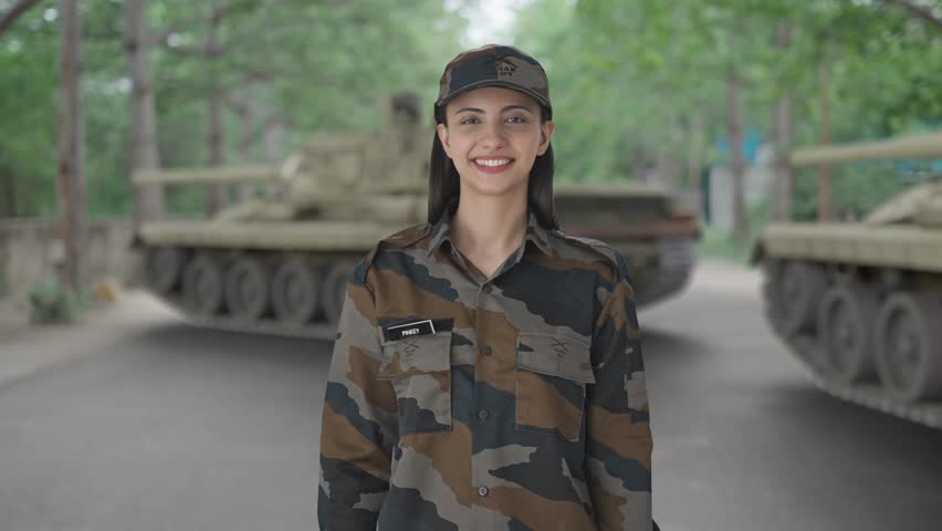 Happy Indian woman army officer showing victory sign
