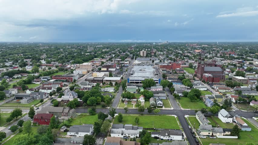 An aerial view of the green city of Buffalo, New York with storm clouds in the distance.