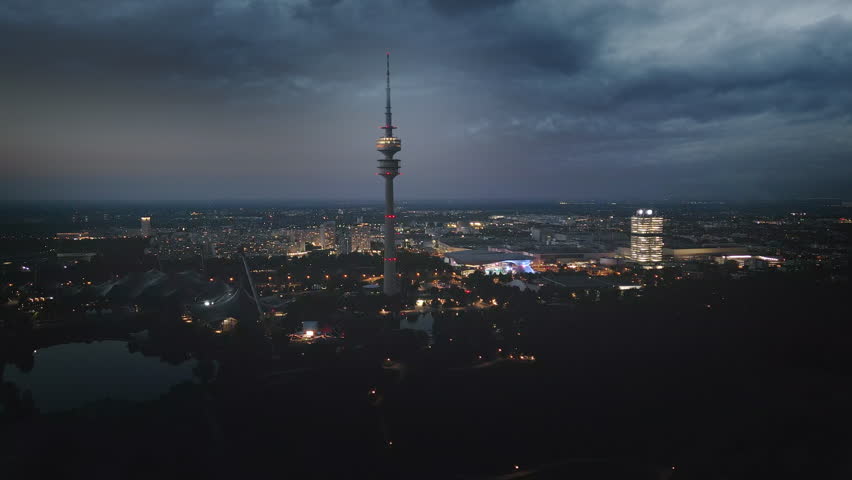 Munich night skyline aerial view drone footage of munich city at night germany view of olympia park tv tower at night munchen germany.