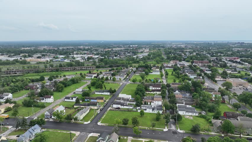 An aerial view of the green city of Buffalo, New York with storm clouds in the distance.