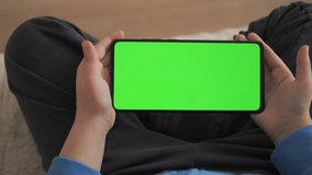 Phone With Green Mock-up Screen Chroma Key Surfing Internet Watching Content Videos Blogs Learning. Little Boy Playing Video Games. Point of View of Child at Living Room Using Phone With Green Mock-up
