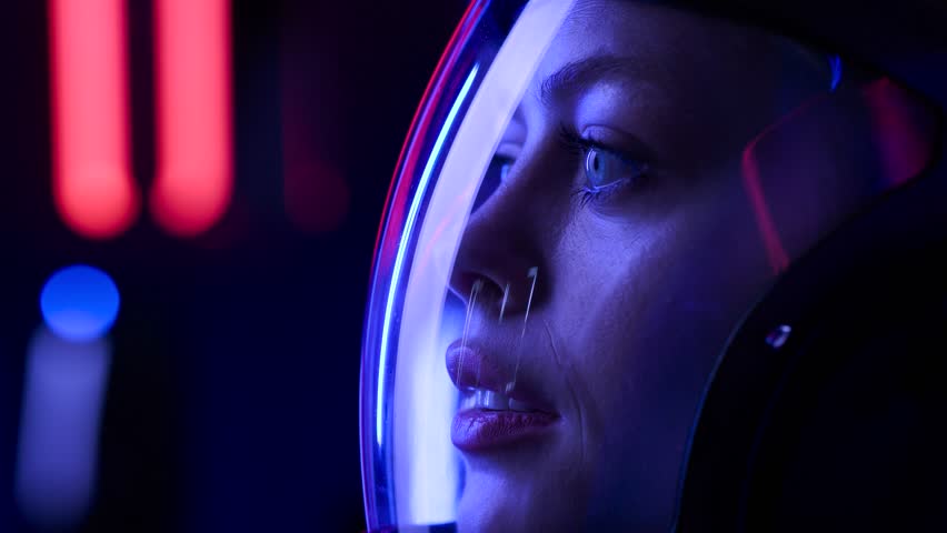 Astronaut in futuristic costume. Girl in glasses of virtual reality while touching air. Augmented reality game, future technology, AI concept. Dark background. Royalty-Free Stock Footage #1108697339