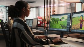 Female Black Game Developer Using Desktop Computer, Designing Unique World And Characters In 3D modelling Software For RPG Video Game. African American Woman Working In Game Design Studio Office.