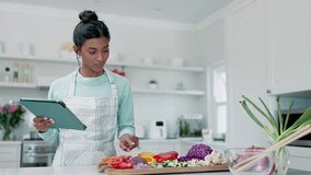 Cooking vegetables, tablet and kitchen woman search online for meal recipe, food instruction or count ingredients. Home nutritionist, health vegan and Indian person watch video, web guide or tutorial