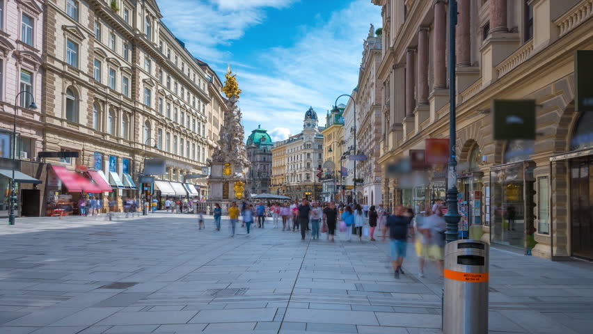 People walking shopping in Graben St. timelapse hyperlapse, old town main street of Vienna with many shops and restaurants, Austria. The column, called The Pestsaule in front,Vienna main street. Royalty-Free Stock Footage #1108705631