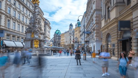 People walking shopping in Graben St. timelapse hyperlapse, old town main street of Vienna with many shops and restaurants, Austria. The column, called The Pestsaule in front,Vienna main street.: film stockowy