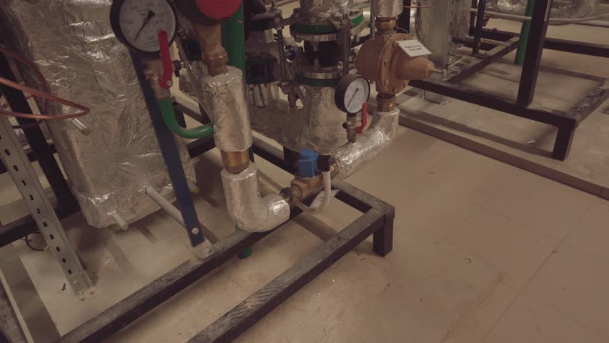 Pipes and taps of the heating system in the boiler room of a residential building Royalty-Free Stock Footage #1108706207