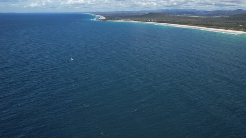 Cabarita Beach With Distant View Of Humpback Whale Swimming Into The Blue Sea In New South Wales, Australia. Aerial Shot Royalty-Free Stock Footage #1108706817