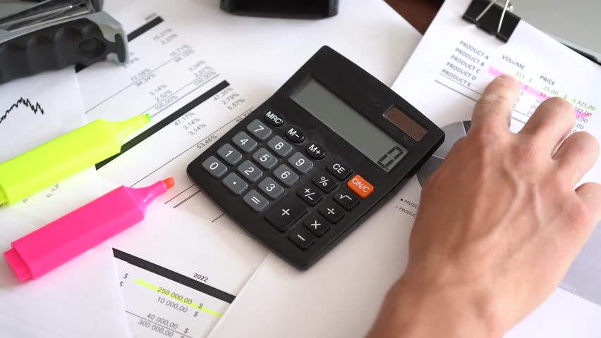 Calculator next to financial documents. concept showing data analysis, accounting and business management | Shutterstock HD Video #1108707739
