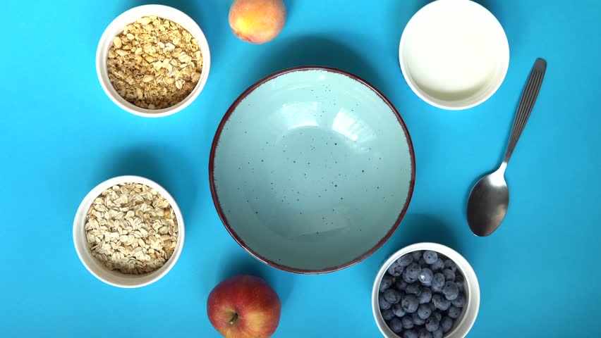 Preparation of nutritious and healthy porridge. Flat lay photo showing the food ingredients needed to prepare a healthy and delicious breakfast | Shutterstock HD Video #1108707941