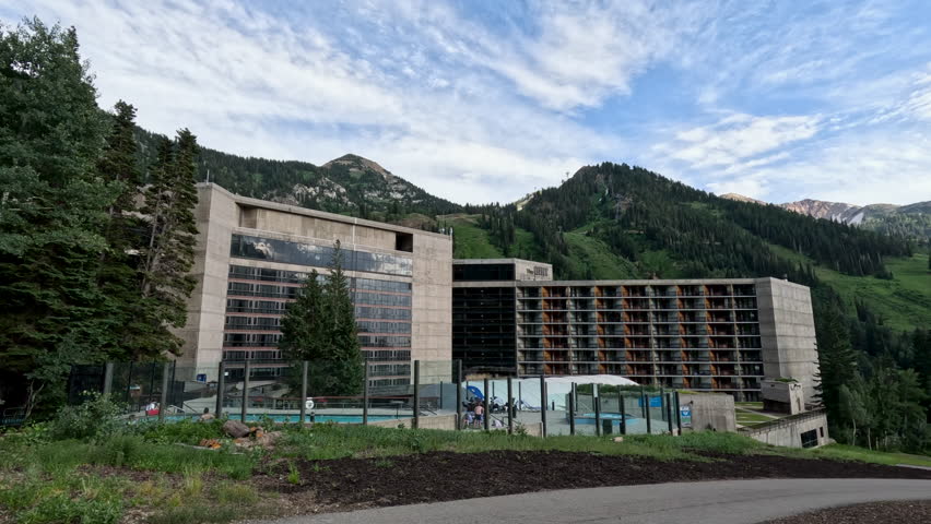 SALT LAKE CITY, UTAH - 1 AUG 2023: Summer ski resort snowbird mountain Utah swimming pool. Summer and winter all season mountain resort. Vacation nature family fun destination. Rocky Mountains.