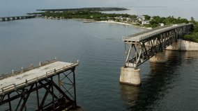 Aerial video of the Flagler Overseas Railway Bridge, A1A Highway, and Bahia Honda state park on Big Pine Key Florida 
