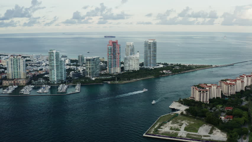 Aerial of Miami and south beach the ocean and the cruise pier, a motorized parachute or paraplane flying in the sky. Florida 