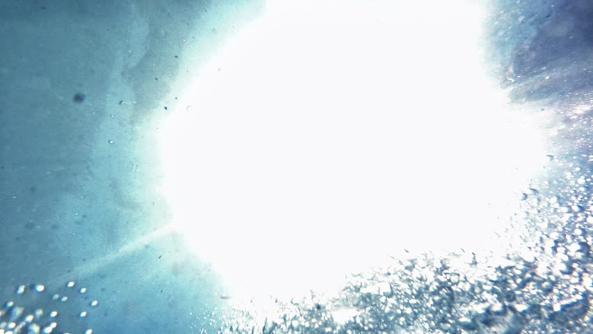 Air bubbles in slow motion, moving from the sea bottom to the water surface, with the soothing effect of sunlight. Ideal for an abstract backdrop.