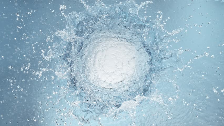 Super Slow Motion Shot of Round Water Splash on Light Blue Background at 1000fps.