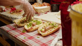 Cooking hot dogs in outdoor fast food restaurant, takeaway festival food truck. Sausages frankfurt and buns are fried and grill for delivery - Powered by Shutterstock - Get 15% off with code: PIKWIZARD15