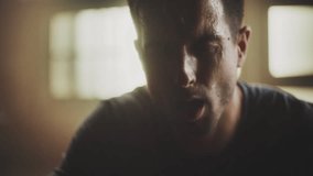 Tired sportsman portrait close-up. Sweaty athlete after intensive workout, posing in gym. Professional trainer face close-up. Slow-motion shot - Powered by Shutterstock - Get 15% off with code: PIKWIZARD15
