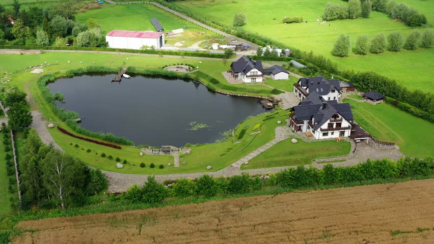 Aerial view with a pond next to new buildings on the Vistula Spit on the Polish Bodden coast near Kaliningrad
