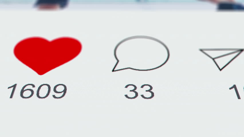 Reacting on post in social network app on a phone or laptop screen. Like comment and share repost icons. Macro close up view Instagram or Tik-Tok. Concept of popularity blogger star and content likes
