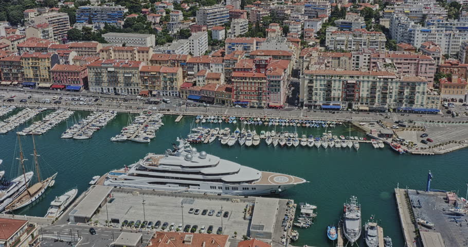 Nice France Aerial v16 birds eye view drone flying around port de nice lympia with yachts and sailboats docked at the harbor, pan around capturing dense urban residential buildings - July 2021