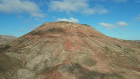 Aerial orbital clip of Montana Roja volcanic mountains near Corralejo Fuerteventura Spain