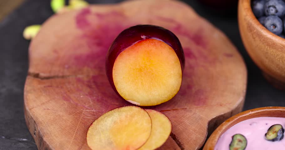 Sliced fresh juicy plum, juicy orange plum on the table | Shutterstock HD Video #1108735081