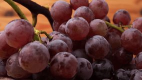 Red grapes rotate on a wooden background. Ripe red grapes. - Powered by Shutterstock - Get 15% off with code: PIKWIZARD15