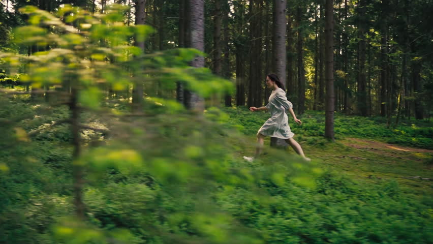 A pretty woman walks dreamily through the early forest full of zest for life