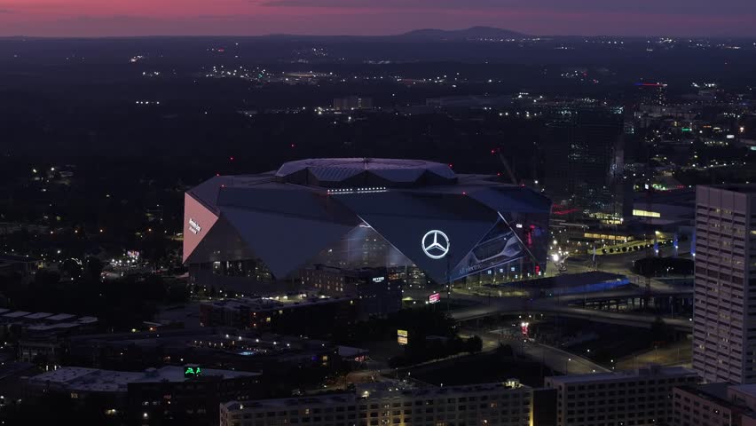 Atlanta, GA, USA - September 9, 2023: Night aerial helicopter drone video tour Mercedes Benz Stadium Atlanta