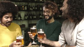 Happy multiracial friends drinking beer at brewery bar. Diverse young people celebrating together cheering with drinks at irish pub, enjoying happy hour time.  - Powered by Shutterstock - Get 15% off with code: PIKWIZARD15