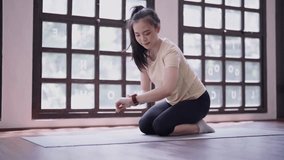 Young Motivated slim athletic Asian woman doing plank on yoga mat in gym, Healthcare health active life concept