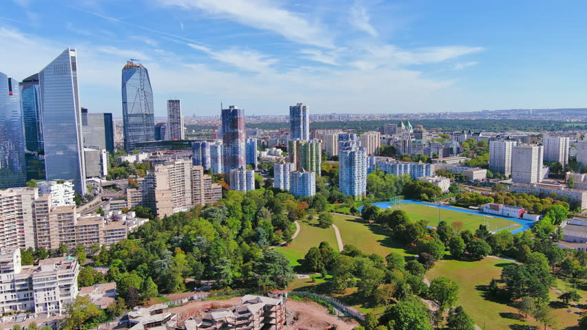Paris: Aerial view of skyscraper skyline of La Defense, major business district in capital city of France from Parc André Malraux park, sunny day with blue sky—landscape panorama of Europe from above Royalty-Free Stock Footage #1108752525