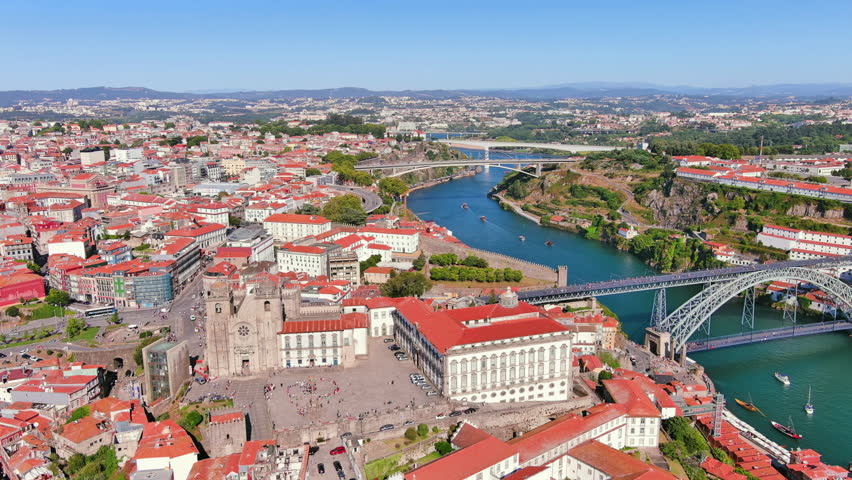 Porto, Portugal: Aerial view of famous historic European city, Ribeira district with Porto Cathedral (Sé do Porto), sunny day with clear blue sky - landscape panorama of Southern Europe from above Royalty-Free Stock Footage #1108753435