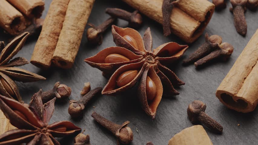 Lots of three spices for mulled wine – star anise, cinnamon and clove slowly scroll clockwise, macro video footage. A great background for your projects. Royalty-Free Stock Footage #1108754221