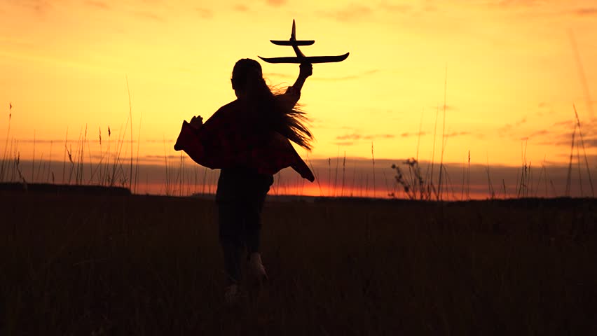 Happy kid girl runs with toy airplane on field in sunset light. Child play toy airplane. Kid aviator dreams of flying becoming pilot. Little girl child wants to become pilot astronaut sky Slow motion | Shutterstock HD Video #1108754791