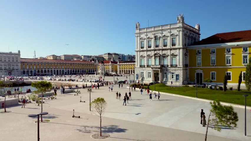 Cinematic aerial view of Lisbon city - Portugal. View of "Praça do Comércio" - Commerce Square in the city center. In front of the square is the river Tagus with promenade area. Travel destination. Royalty-Free Stock Footage #1108756955