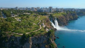 Slowmotion aerial video of the Lower Duden Waterfall in the city of Antalya. The drone is hovering above the Duden park.