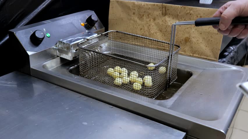 Top view cheese balls are being fried in the boiling oil. Oil is boiling over electric fryer.Food concept. | Shutterstock HD Video #1108760079